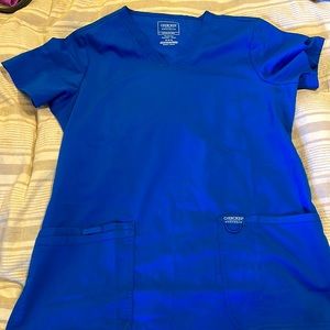 Royal blue scrub top. Washed but never worn. Size M.